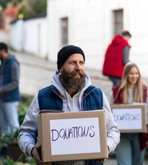diverse-group-of-volunteers-with-donation-boxes-standing-outdoors-social-care-and-charity-concept.jpg